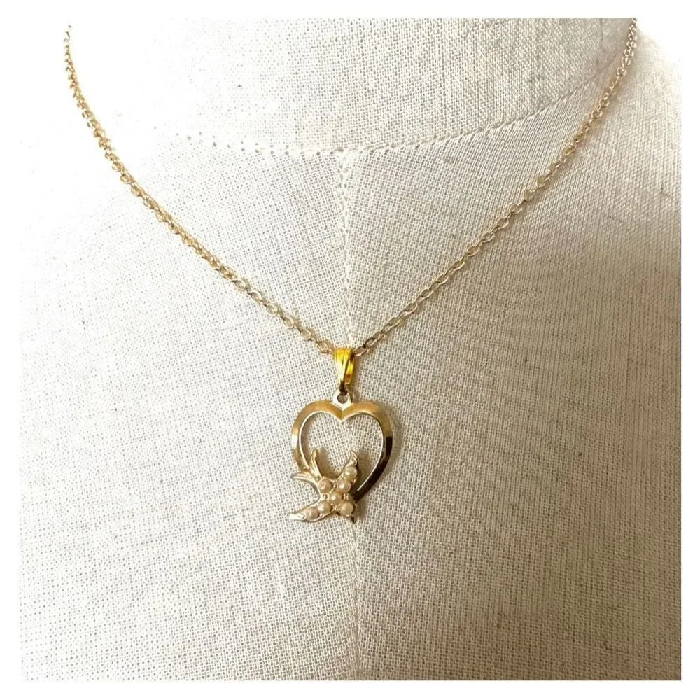 Gold tone heart with faux pearl bird pendant necklace